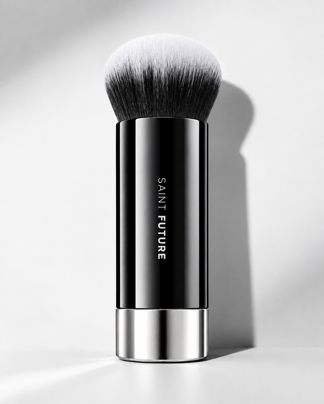 Saint Future F101 foundation brush standing on white, with a dense dual-tone kabuki head and chrome base