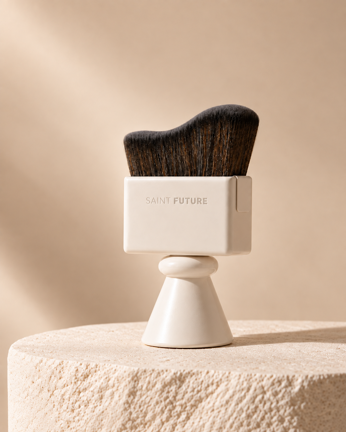 Cream Saint Future Pocket Brush standing on stone, with a wave-cut head on a sculptural handle