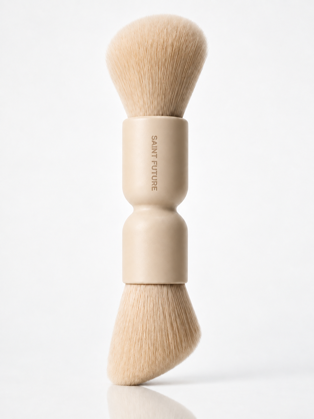 Saint Future Pocket Dual Brush on white, with a round powder head and an angled sculpt head